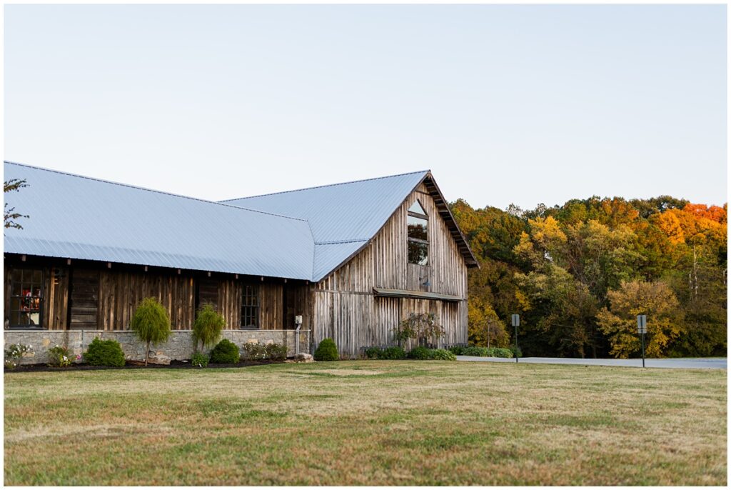 L&L Farm's beautiful historic barn in the Autumn foliage during a sunset wedding reception.